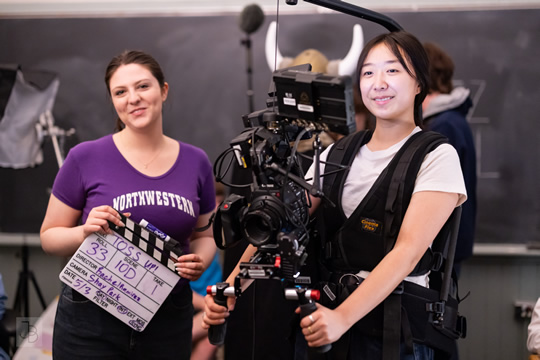 students with clapboard and camera