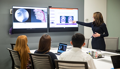 Professor Bonnie Martin-Harris presents throat x-rays on double video screen