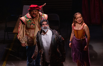 Sancho, Quixote and Aldonza stand on stage together singing.